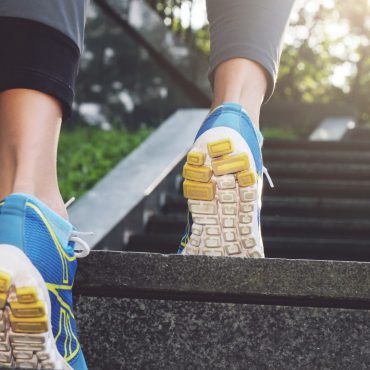 Athlete runner feet running in nature, closeup on shoe. Athlete runner feet running in nature, closeup on shoe. Female athlete running on stairs. Woman fitness, running, jogging, sport, fitness, active lifestyle concept